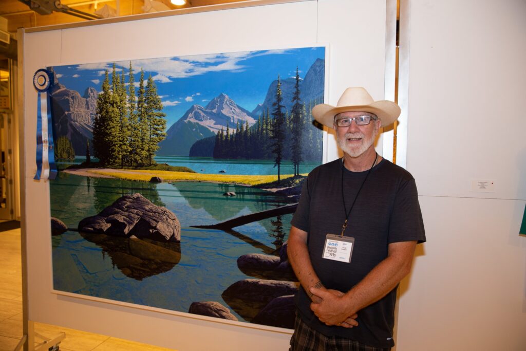 Painter Scott Coulter stands next to “Composed of Stone and Wishful Thinking,” which won Best of Show at the 53rd Annual Raymond James Gasparilla Festival of the Arts and a $15,000 top prize. 